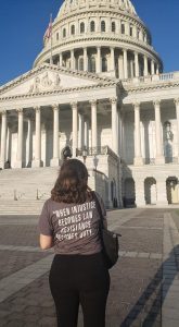 Staff outside Capitol Building wearing a shirt that says 'When injustice becomes law, resistance becomes duty."